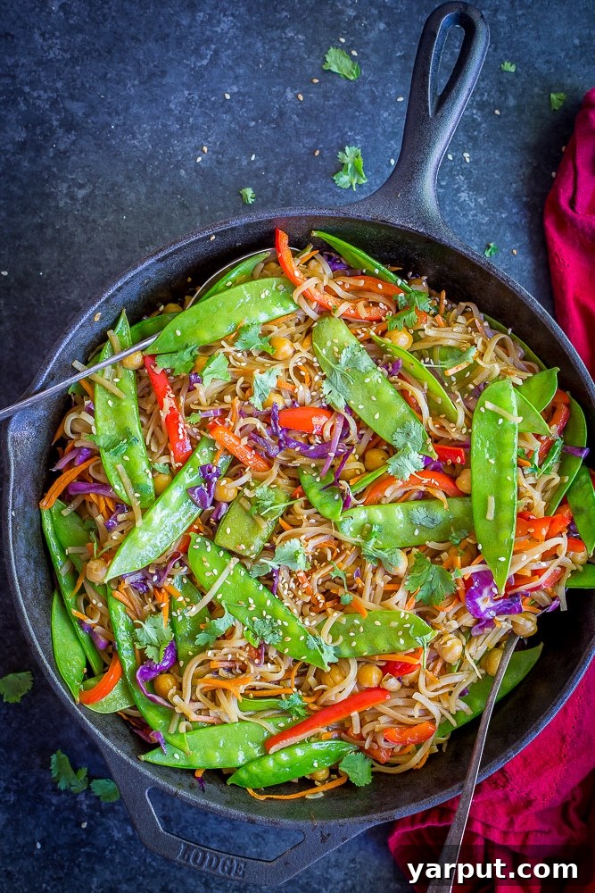 Flavor-Packed 30-Minute Sesame Ginger Veggie Noodles 4 A vibrant bowl of 30 Minute Sesame Ginger Noodles with a rich sauce, assorted vegetables, and chickpeas, ready to be enjoyed as a quick and healthy vegan meal.