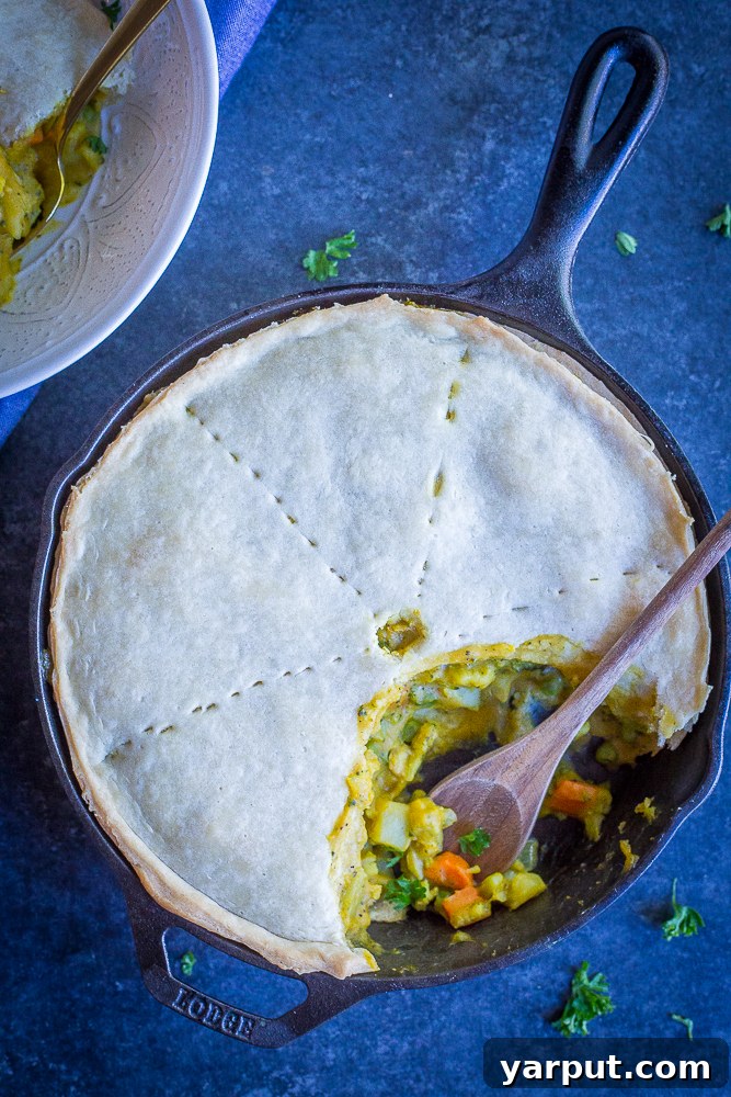 Golden Curry Veggie Pot Pie 4 Freshly baked Curried Vegetable Pot Pie cooling, with a golden-brown, flaky crust, ready to be served. Ideal for a hearty vegan dinner. #vegan #vegetarian #dinner #comfortfood #potpie