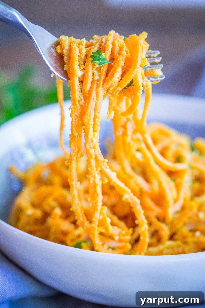 Close-up of freshly spiralized sweet potato noodles, ready to be cooked and transformed into a delicious garlic parmesan dish.
