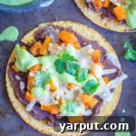 A beautifully plated Roasted Butternut Squash Tostada with Avocado Lime Sauce