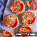 Close-up of a single vegan lentil meatloaf cup with ketchup glaze, ready for serving.