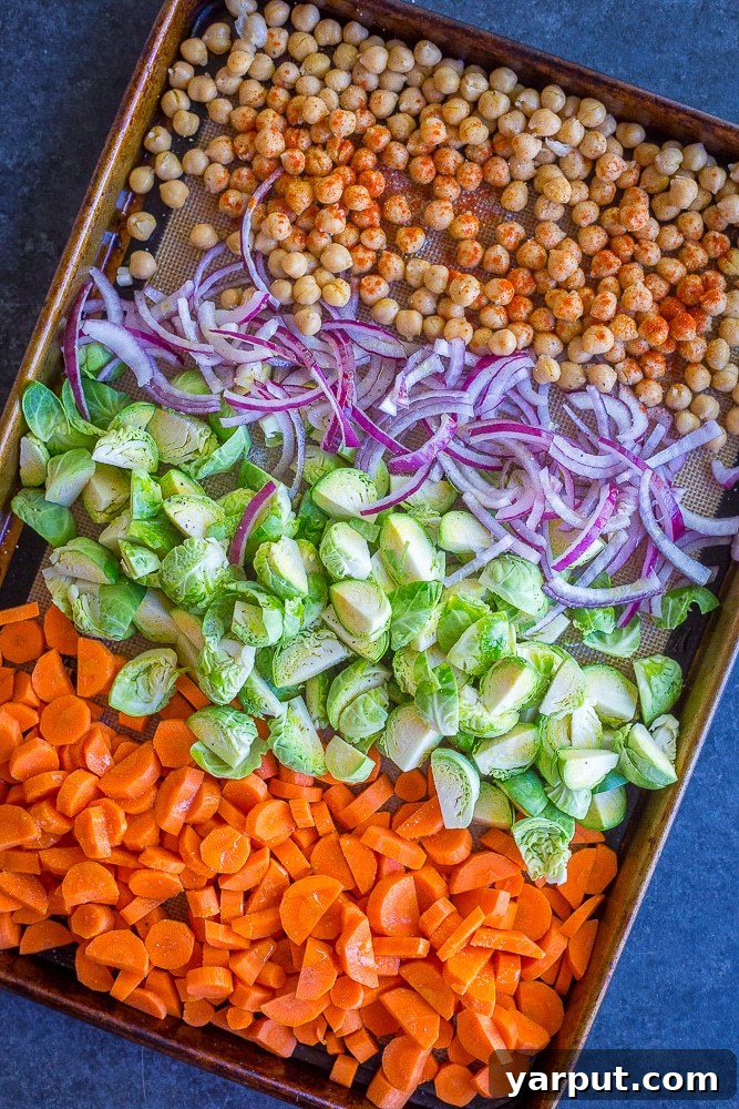 A close-up shot of a single Roasted Vegetable and Chickpea Meal Prep Bowl with fluffy quinoa and fresh herbs.