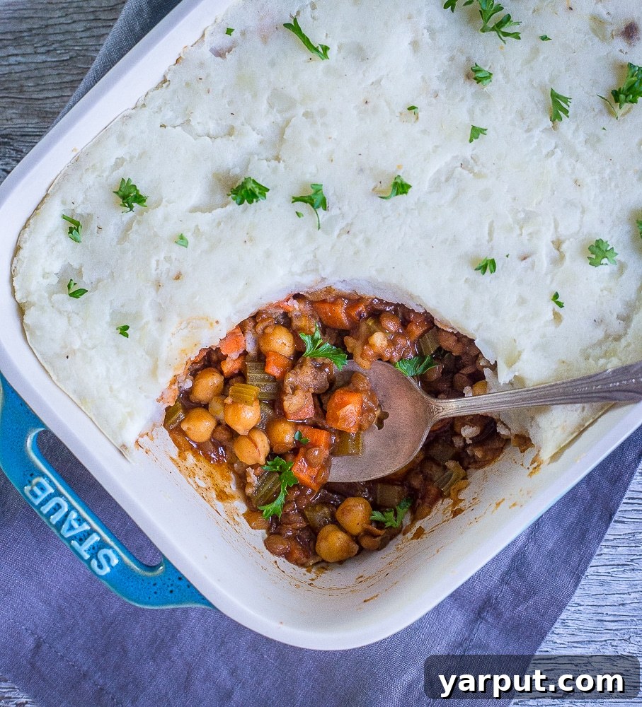 Smoky BBQ Lentil & Chickpea Shepherd's Pie 4 A vibrant display of fresh ingredients for BBQ Shepherd's Pie with Chickpeas and Lentils, including russet potatoes, carrots, celery, onion, and a can of chickpeas.