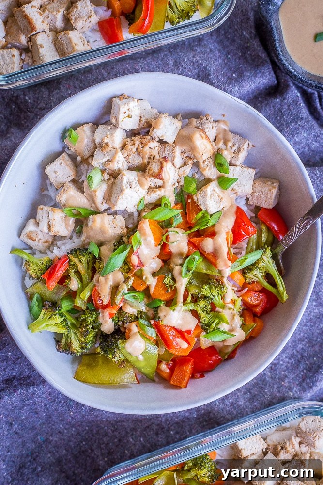 One-Pan Ginger Peanut Tofu Power Bowls 5 Close-up of crispy roasted tofu and tender vegetables on a sheet pan, ready to be served.