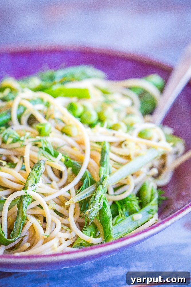 Bright Spring Pasta with Zesty Lemon and Fresh Dill 4 A beautiful plate of Spring Vegetable Pasta garnished with fresh lemon slices and a sprig of dill.