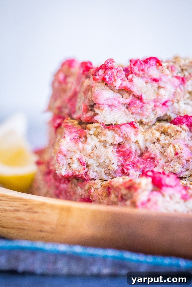 Sun-Kissed Lemon Raspberry Baked Oats 2 Lemon Raspberry Baked Oatmeal Stacked up in a wooden dish