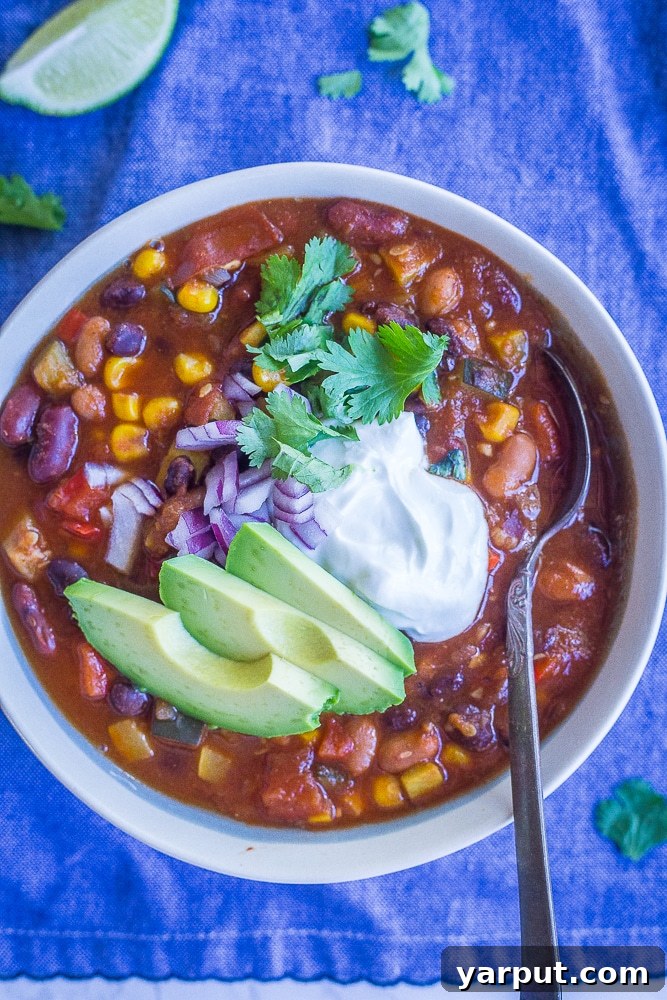 Summer Garden Instant Pot Vegetarian Chili 5 A vibrant bowl of Instant Pot Vegetarian Chili on a blue napkin, ready to be enjoyed