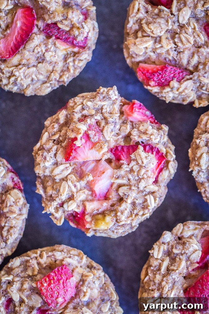 Wholesome Strawberry Banana Baked Oatmeal Cups 6 A cutting board filled with sliced bananas and fresh strawberries, ingredients for the baked oatmeal cups.