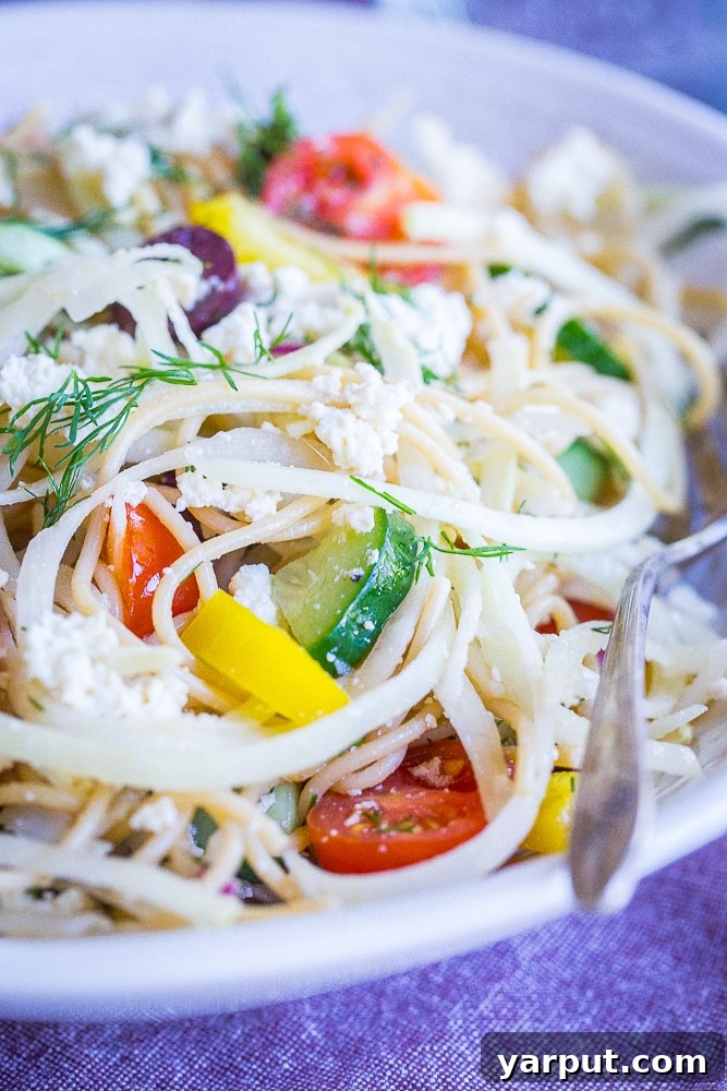 Mediterranean Kohlrabi Noodle Salad 6 The vibrant front view of a bowl filled with Healthy Greek Pasta Salad with Kohlrabi Noodles, highlighting its freshness and appeal.