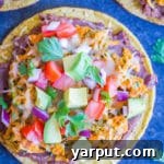 A finished Sweet Potato and Zucchini Tostada with toppings