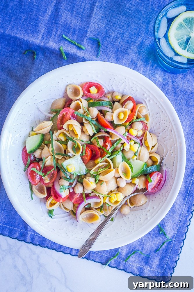 Vibrant Summer Chickpea Pasta Salad 4 A side shot of the Summer Vegetable Pasta Salad, showcasing the abundant chickpeas and the light, flavorful dressing.