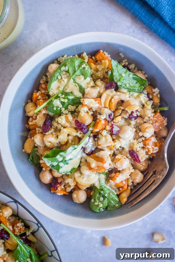 Golden Curry Quinoa Power Bowl 5 A close-up shot of a single serving bowl of Quinoa Sweet Potato Chickpea Salad, highlighting its vibrant colors and appealing textures.