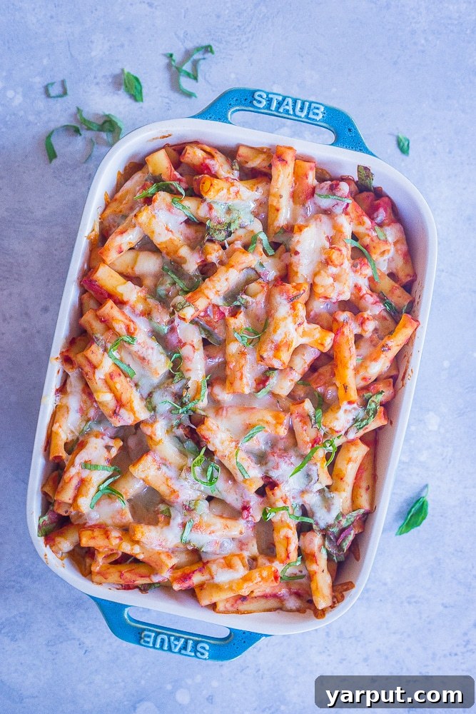 A close-up shot of the Five-Ingredient Baked Ziti, showcasing the rich sauce, melted cheese, and fresh spinach