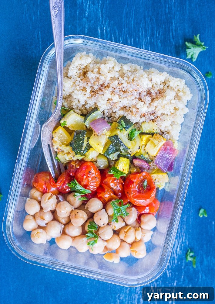 Roasted Summer Harvest Meal Prep Bowls 6 A single Roasted Summer Vegetable Meal Prep Bowl, showcasing its vibrant contents and a fork ready to enjoy, with a side of balsamic dressing, emphasizing a delicious and convenient healthy lunch option.