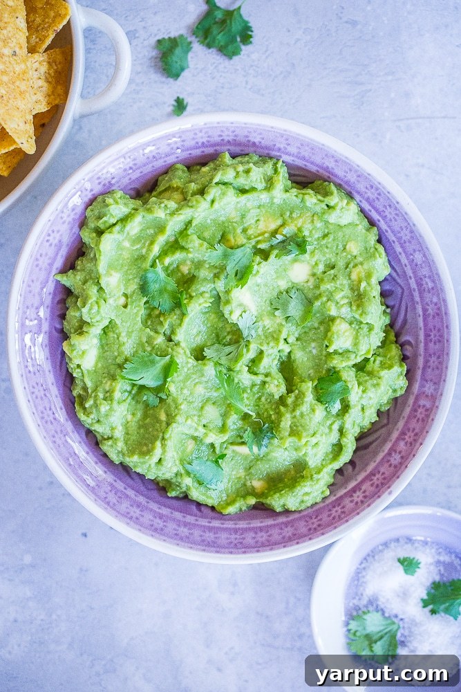 Perfect Guacamole Made Simple 6 Another enticing view of The Best Easy Guacamole Recipe in a purple bowl, ready to be devoured with a side of chips.