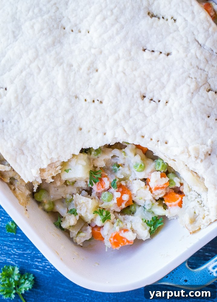 Close up of Creamy Vegan Pot Pie, showing a rich, bubbly interior and a perfectly baked golden crust