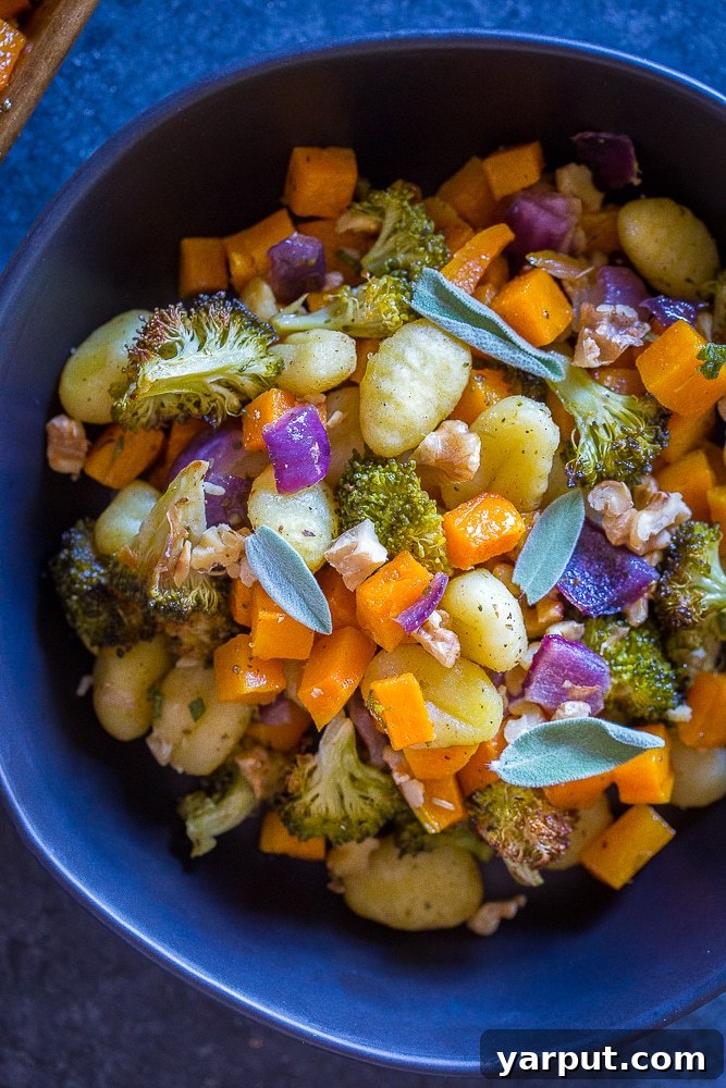 Golden Gnocchi & Harvest Veggie Sheet Pan 6 A rustic presentation of Sheet Pan Roasted Gnocchi, Butternut Squash and Broccoli in a serving bowl, garnished with fresh herbs, ready for a comforting meal.