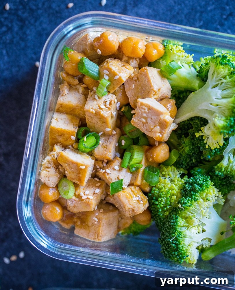 Bright Citrus Tofu & Chickpea Meal Prep Bowls 5 Closeup of Orange Tofu Chickpea Bowls in a meal prep container, demonstrating convenience