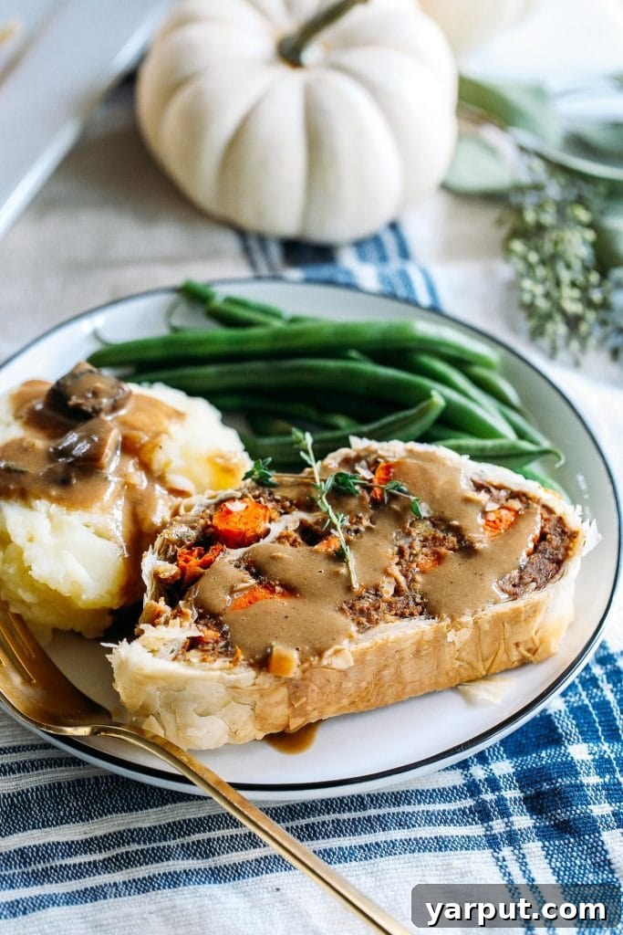 67 Vegan Holiday Recipes: Appetizers, Side Dishes, Salads, Main Courses, and Desserts 53 Vegan Wellington sliced on a plate