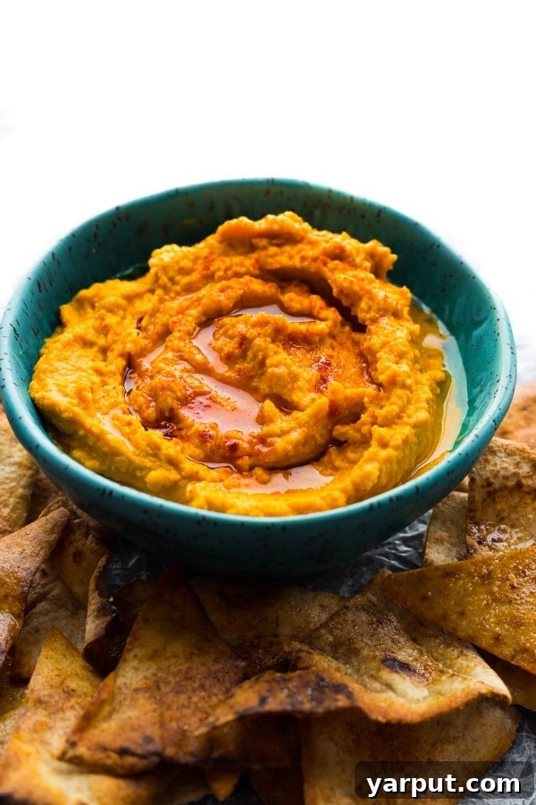 67 Vegan Holiday Recipes: Appetizers, Side Dishes, Salads, Main Courses, and Desserts 8 Savory Pumpkin Hummus in a serving bowl