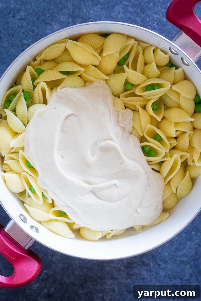 Velvet Vegan Alfredo and Crispy Chickpea Delight 4 Pot of pasta with cauliflower Alfredo sauce mixed in, ready for Vegan Cauliflower Alfredo with Crispy Chickpeas