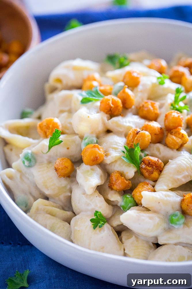 Velvet Vegan Alfredo and Crispy Chickpea Delight 5 Close up shot of a bowl of Vegan Alfredo Pasta with Crispy Chickpeas, highlighting texture and sauce