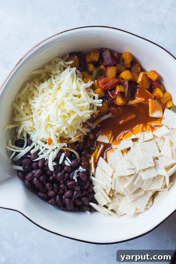 A bowl of fresh ingredients for Black Bean Enchilada Casserole with Butternut Squash, showcasing diced vegetables and black beans
