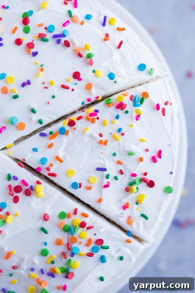 Glutensiz Lezzetin Zirvesi: Beyaz Kek 5 Top view of Best Gluten Free White Cake with a slice cut out of it