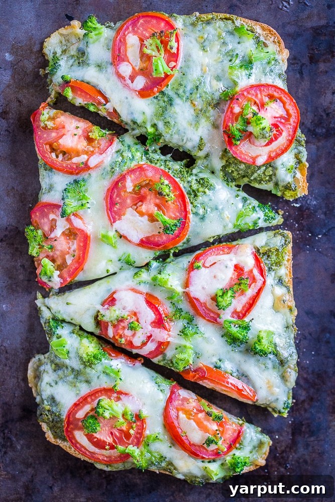 30-Minute Vegetarian Pesto French Bread Pizza Perfection 2 Delicious 30-Minute Vegetarian French Bread Pizzas with Pesto, Tomato, and Broccoli, sliced on a baking sheet, ready to serve.