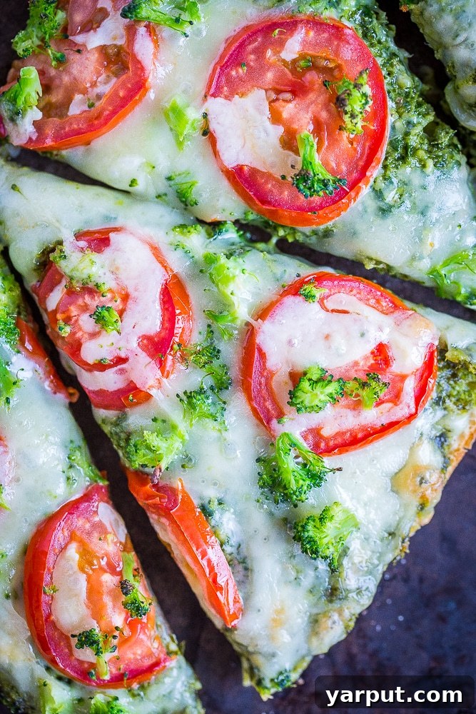 30-Minute Vegetarian Pesto French Bread Pizza Perfection 4 Close-up shot of baked 30-Minute Vegetarian French Bread Pizzas with vibrant pesto, melted cheese, roasted tomatoes, and tender broccoli.