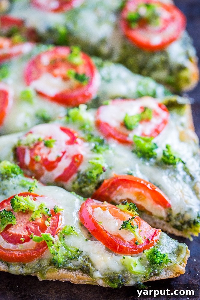 30-Minute Vegetarian Pesto French Bread Pizza Perfection 5 Another close-up of the baked vegetarian French bread pizza, highlighting the vibrant colors and appealing texture of the toppings.
