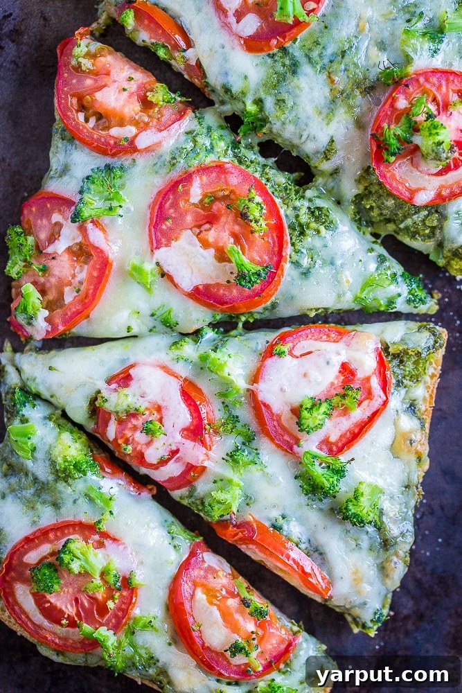 30-Minute Vegetarian Pesto French Bread Pizza Perfection 6 Sliced 30-Minute Vegetarian French Bread Pizzas with Pesto, Tomato, and Broccoli on a sheet pan, ready for serving.