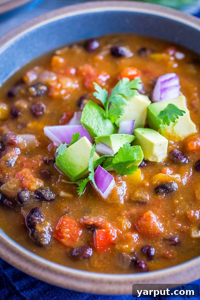 A close-up of a rustic bowl of Butternut Squash Chili with Black Beans, ready to be enjoyed.