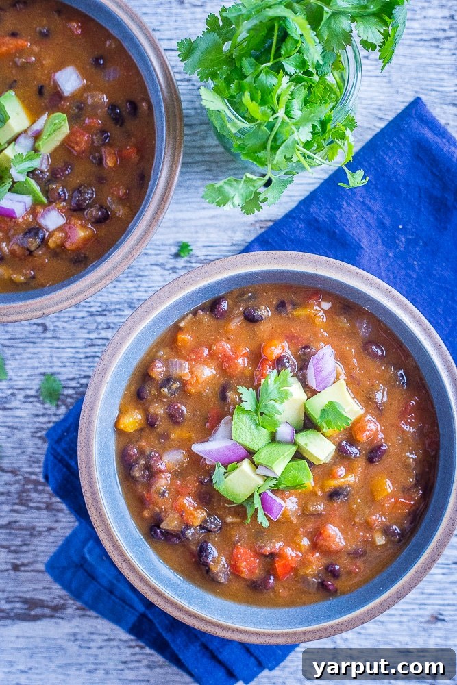 Two inviting bowls of Butternut Squash Chili with Black Beans, ready to be enjoyed.