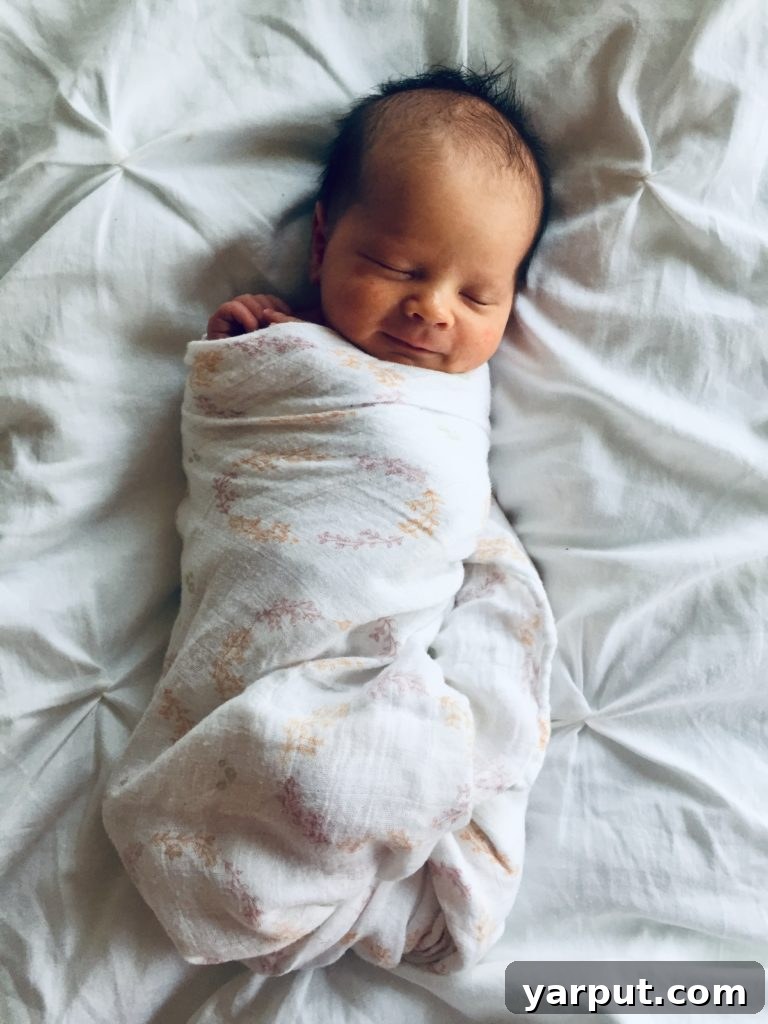 Meet Sawyer 2 A sweet, sleeping newborn baby wrapped in a blanket, signifying a new arrival and the focus of the blog post.