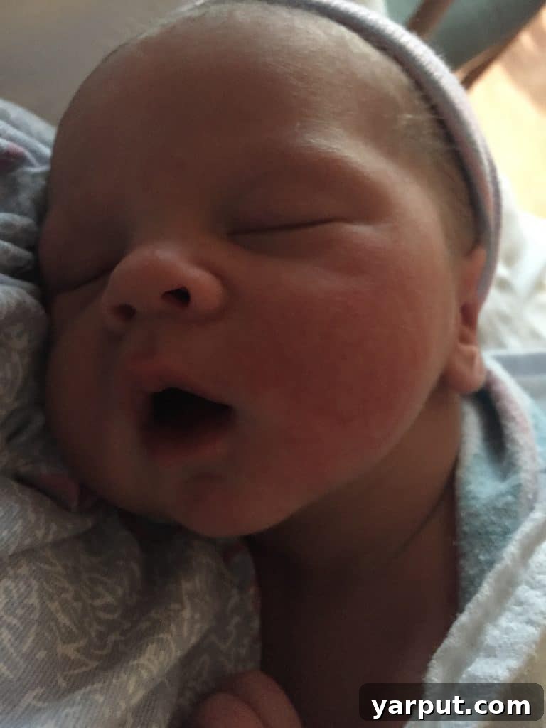 Sawyer's Grand Entrance 4 A pregnant woman resting in a hospital bed, hands on her bump, reflecting on the labor journey ahead.