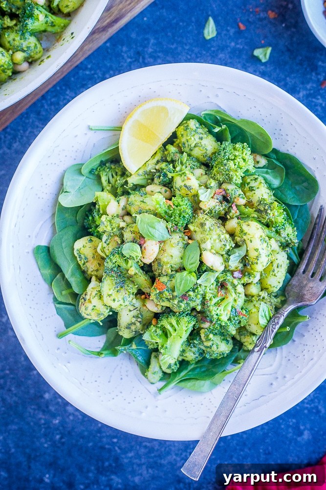 A Pinterest-friendly image of the Pesto Gnocchi with White Beans and Broccoli in a rustic bowl
