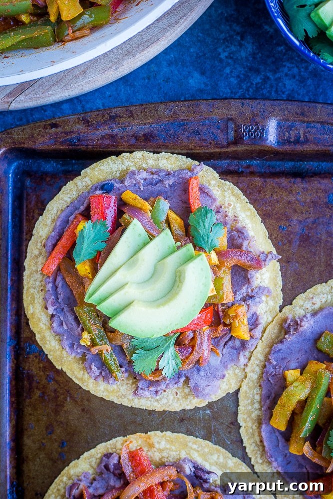Sizzling 30-Minute Fajita Tostadas 2 Sheet pan loaded with freshly prepared Fajita Tostadas, showcasing vibrant vegetables and crisp tostada shells