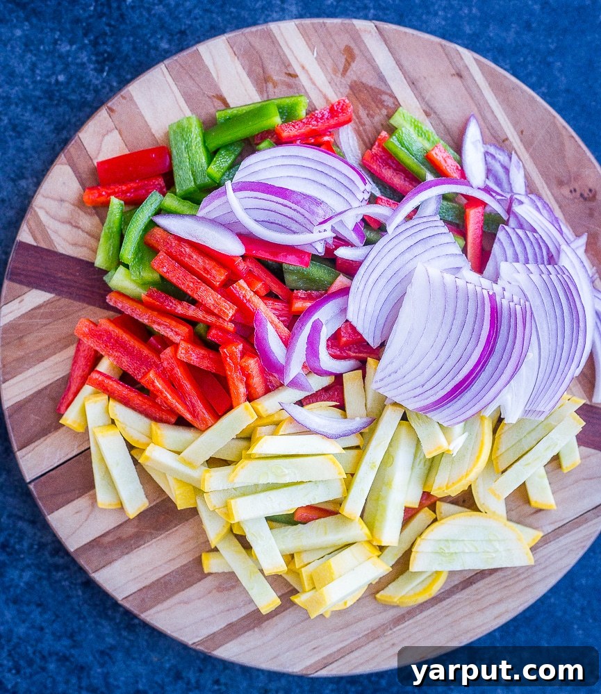 Sizzling 30-Minute Fajita Tostadas 3 Assorted bell peppers, onions, and yellow squash, perfectly sliced and ready for cooking, on a wooden cutting board