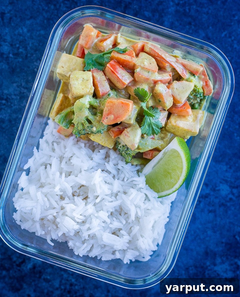 Wholesome 30-Minute One-Pot Coconut Tofu Curry 6 Meal prep containers filled with Easy Coconut Curry and rice, ready for convenient lunches or dinners.