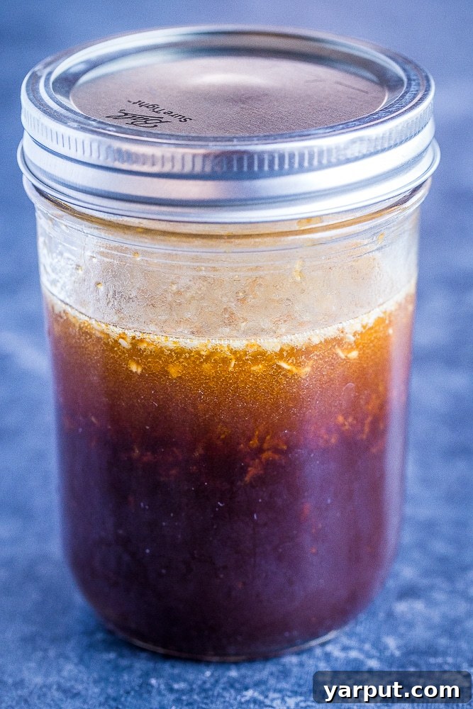 The Perfect Wholesome Stir Fry Sauce 2 The Best Stir Fry Sauce in a mason jar, showcasing its rich texture and appealing color, ready to elevate any meal.