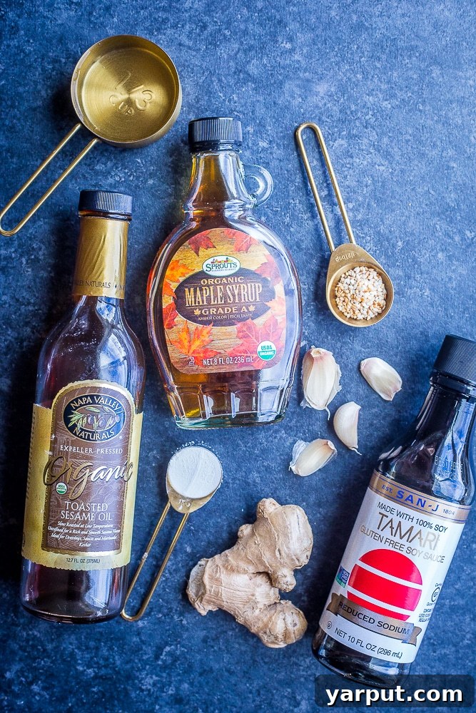 The Perfect Wholesome Stir Fry Sauce 3 All the fresh ingredients laid out for this easy best stir fry sauce, including tamari, maple syrup, sesame oil, ginger, and garlic.