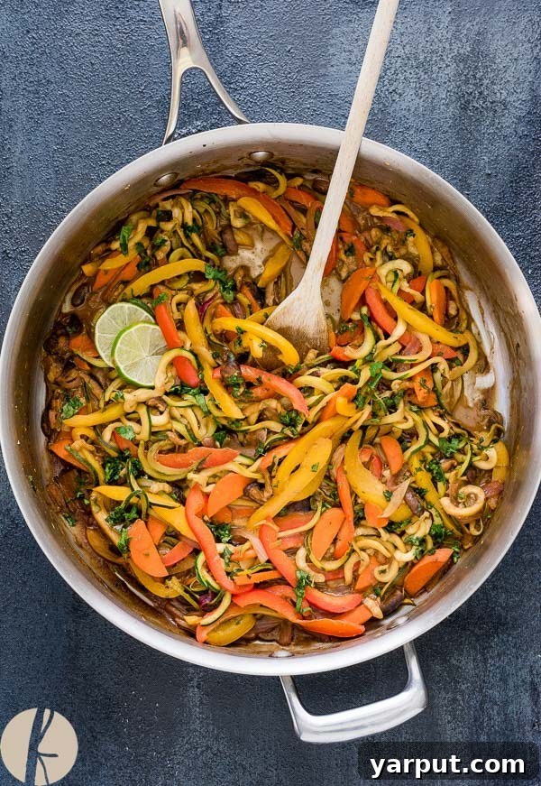26 Vegan One-Pot Wonders for Easy Weeknights 11 Vibrant Thai Peanut Zucchini Noodles in a bowl, garnished with peanuts and fresh herbs
