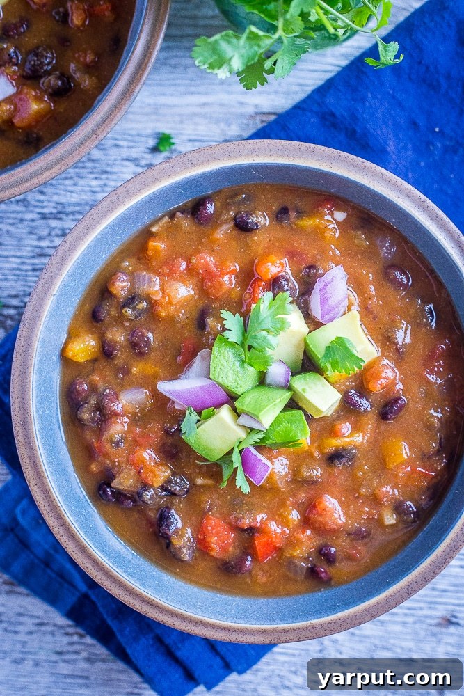 26 Vegan One-Pot Wonders for Easy Weeknights 6 Hearty Butternut Squash Chili with Black Beans, garnished with fresh herbs