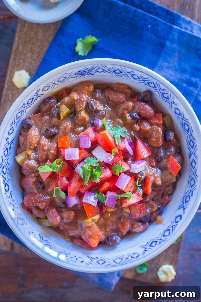 26 Vegan One-Pot Wonders for Easy Weeknights 10 The Best Vegan Chili served in a rustic bowl with toppings like avocado and fresh cilantro