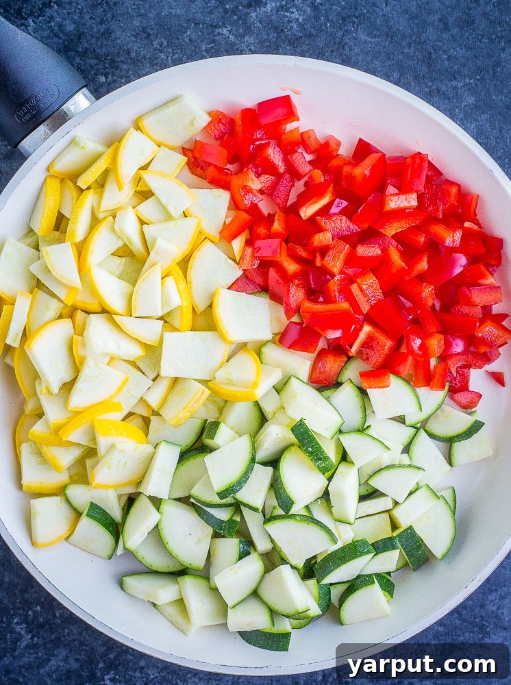 Vibrant Summer Vegan Black Bean Tacos 3 A close-up shot of chopped zucchini, yellow squash, and red bell pepper sautéing in a pan, ready to become the delicious filling for Vegan Black Bean Tacos