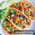A plate of Vegan Black Bean Tacos with Summer Vegetables