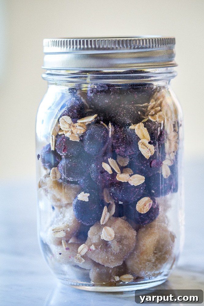 Meal prep smoothie ingredients layered in a glass jar