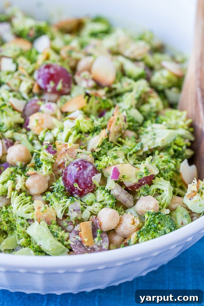 Vibrant Broccoli Salad with Golden Tahini Dressing 6 A vibrant, close-up shot of the creamy broccoli salad, showcasing its textures and the rich coating of the curry tahini dressing.