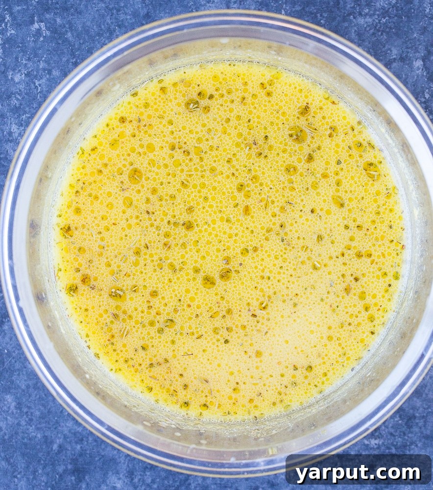 Homemade Vegan Feta Perfection 4 A glass bowl containing a rich, vibrant vegan feta cheese marinade, ready for tofu